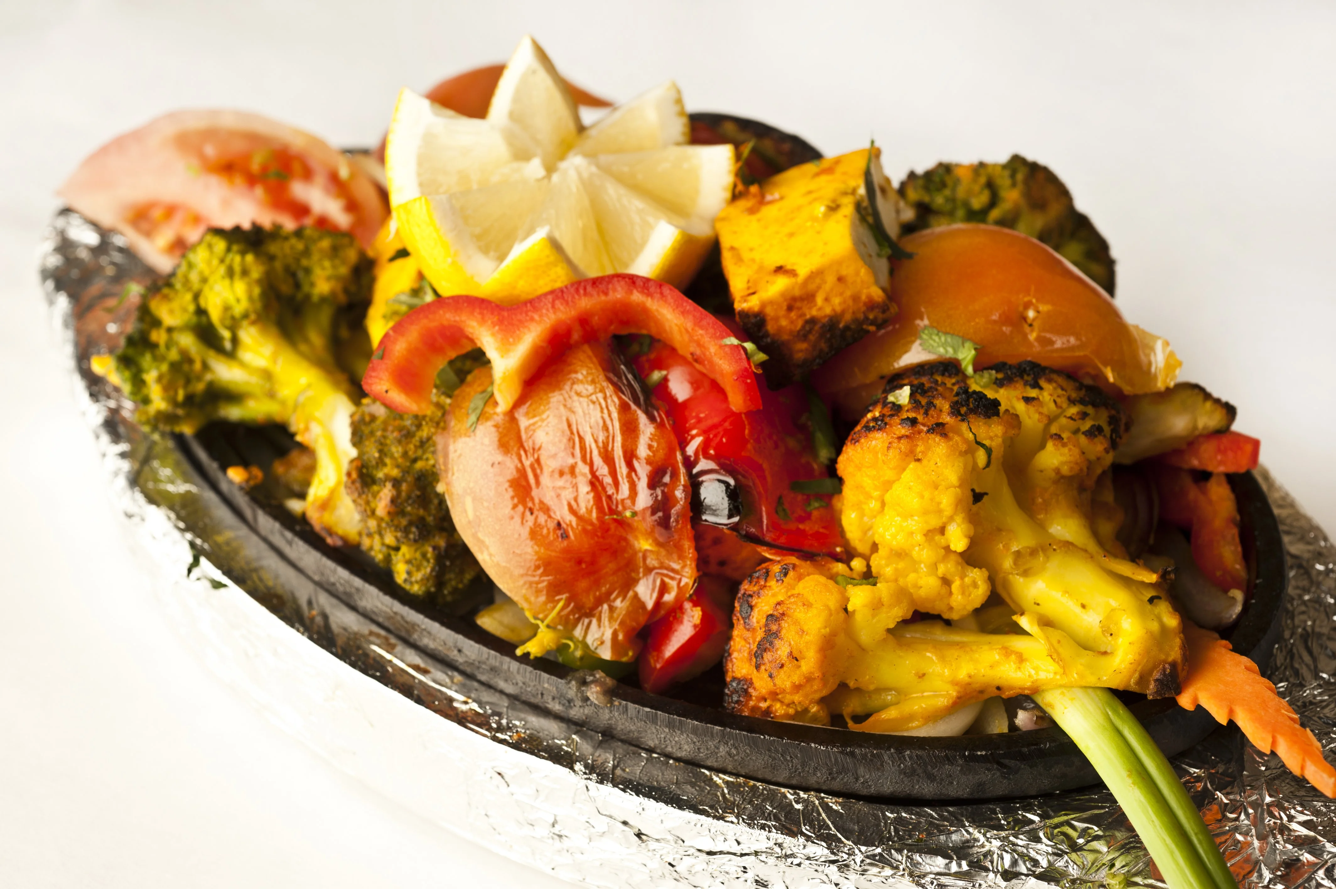 Sizzling Indian vegetable tikka on a hot plate