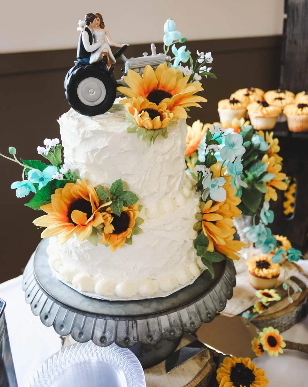 Wedding cake with tractor topper and sunflowers