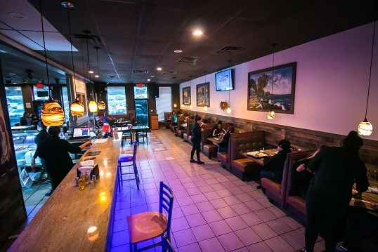Cozy restaurant interior with warm lighting and seating areas