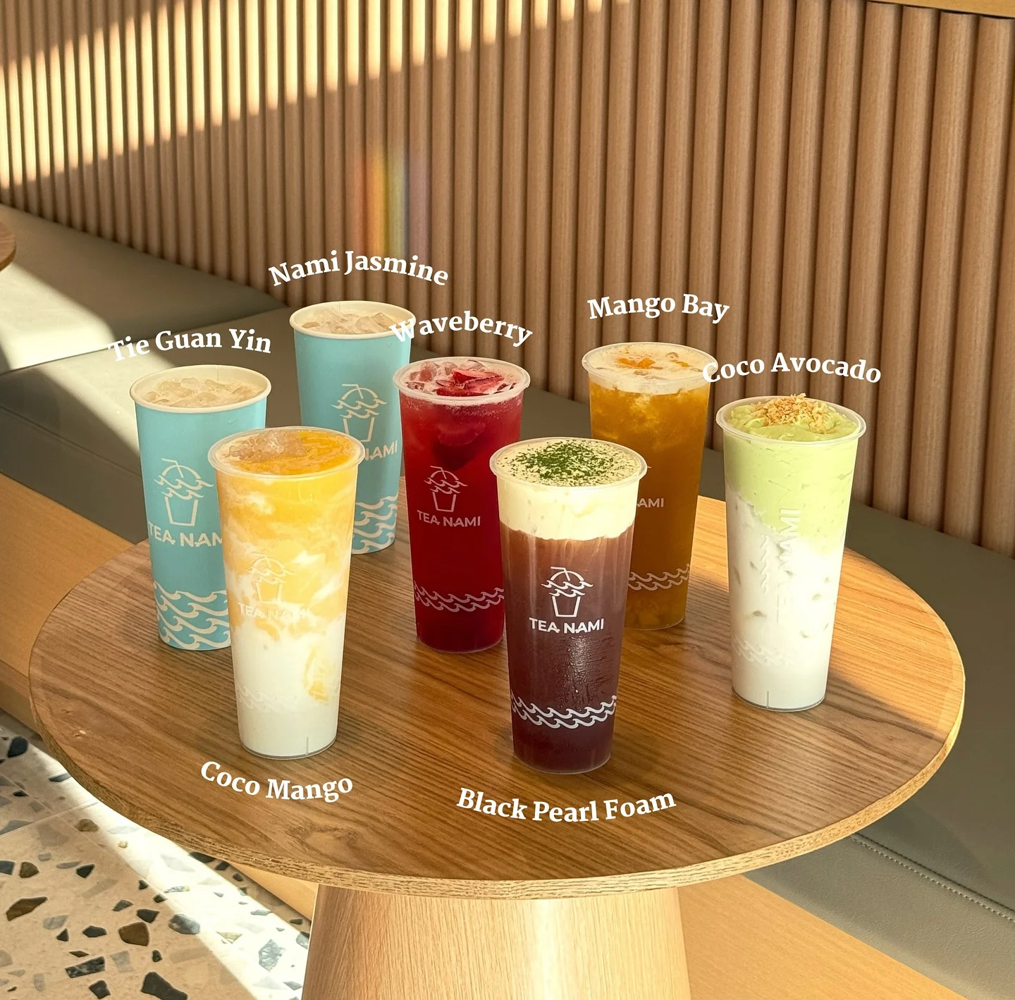 Variety of colorful bubble teas on a wooden table