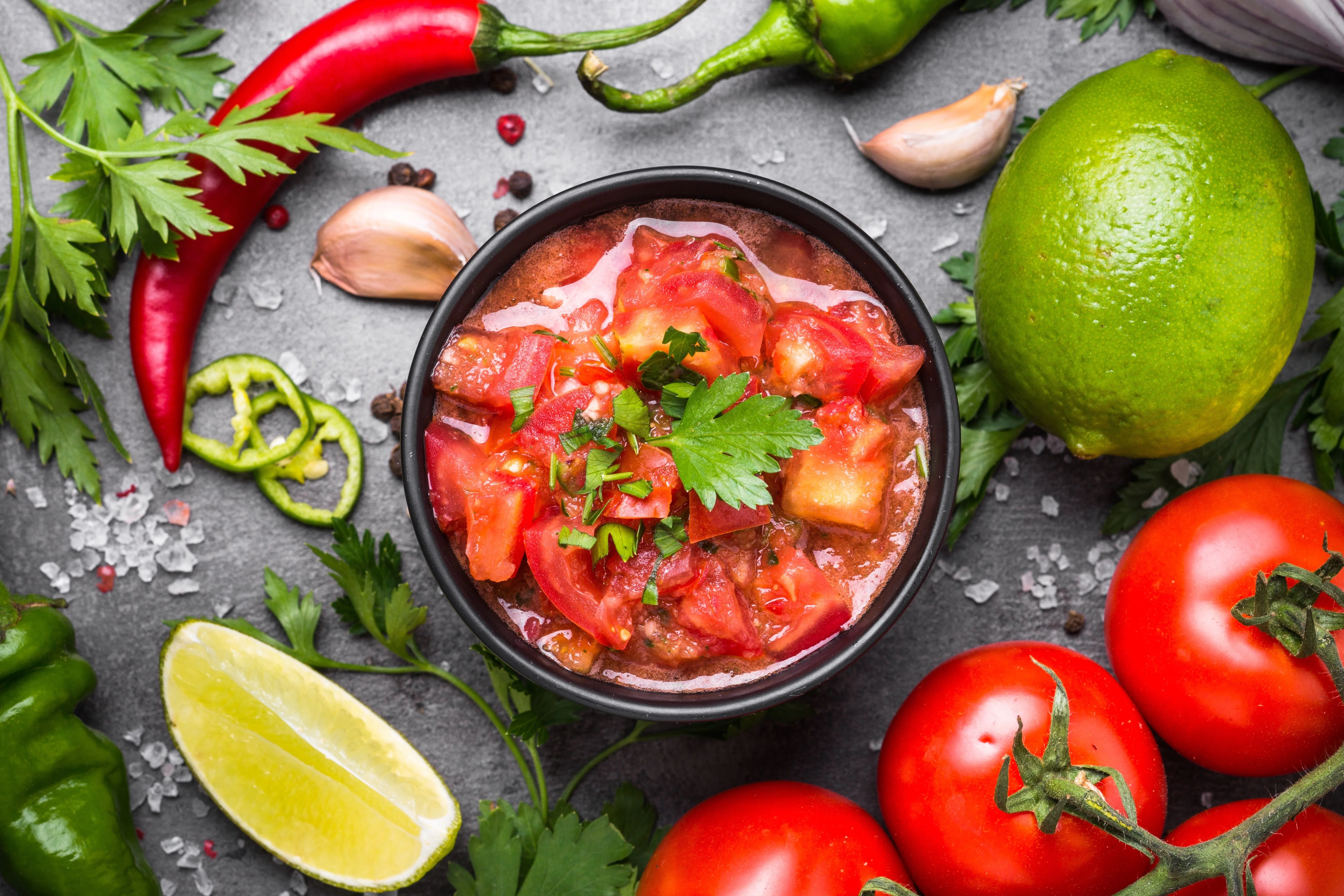 Fresh Mexican salsa in a bowl with herbs