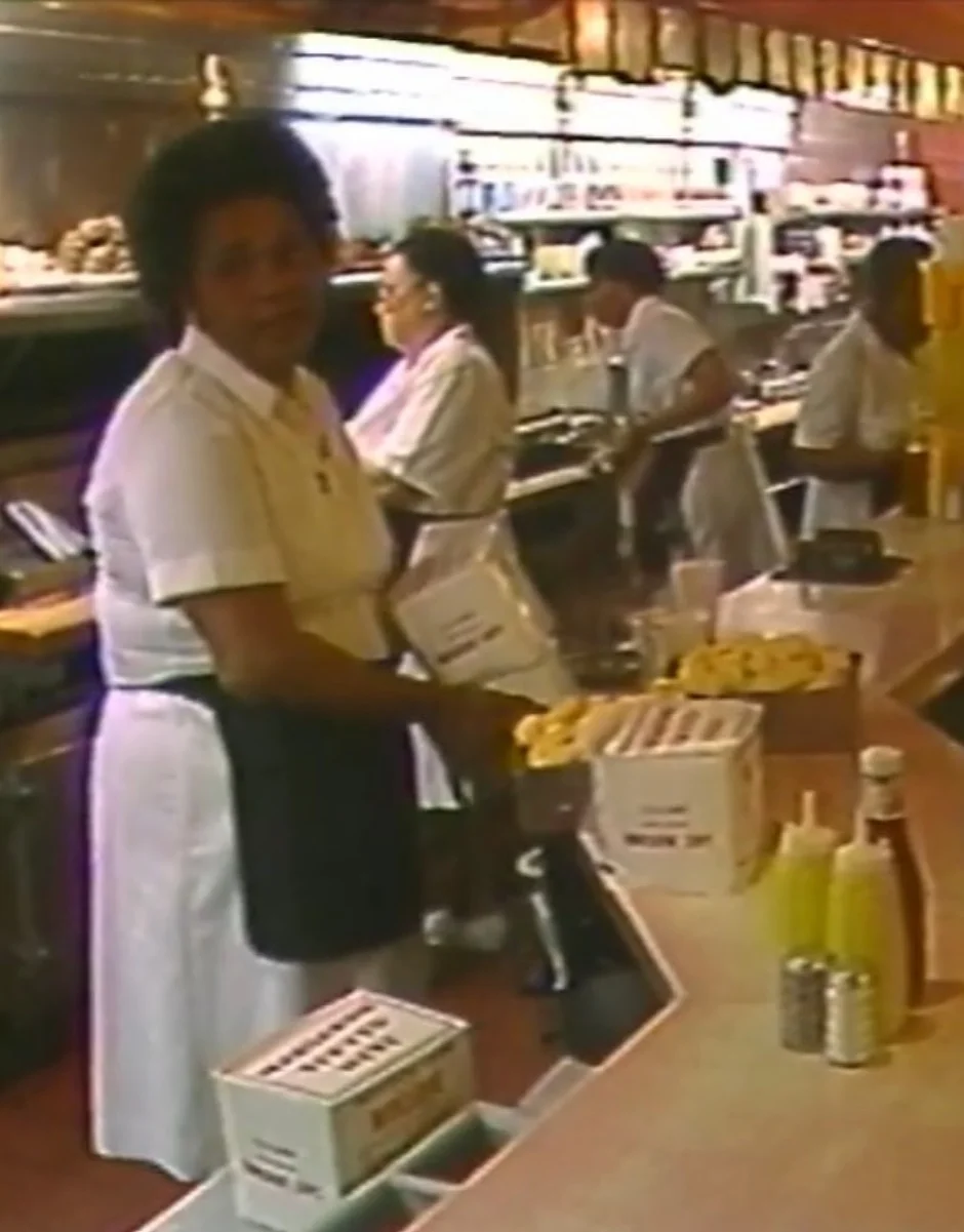 Vintage restaurant counter with staff serving guests