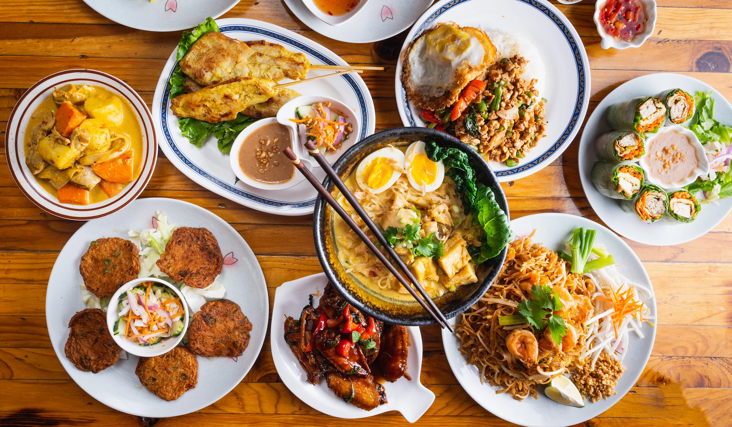 Assorted Thai dishes including pad thai and curry