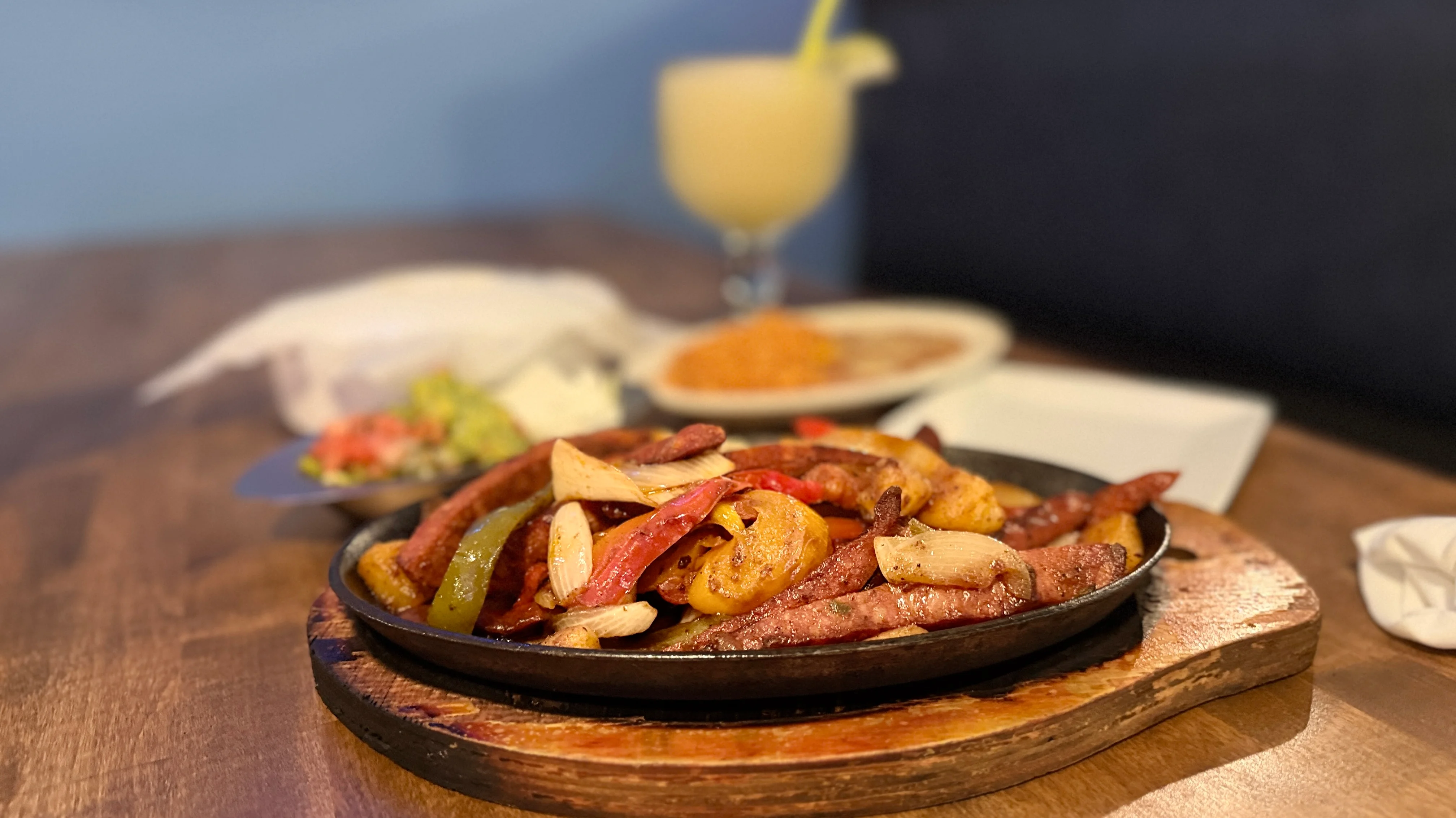Sizzling fajitas served on a hot skillet