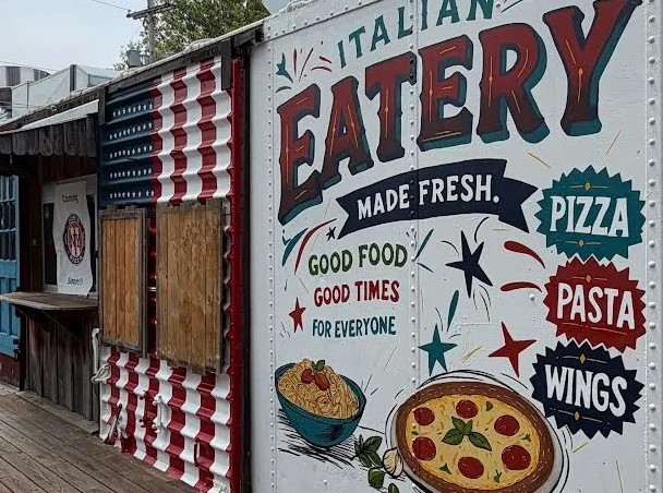 Colorful Italian eatery sign showcasing pizza and pasta offerings