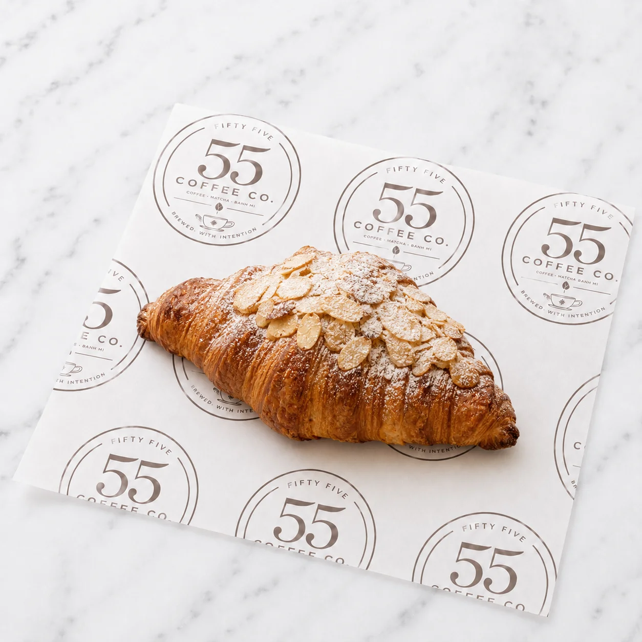 Almond croissant on branded paper