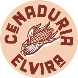 A circular logo featuring an illustration of corn on a beige background with the text 'CENADURIA ELVIRA' around it.