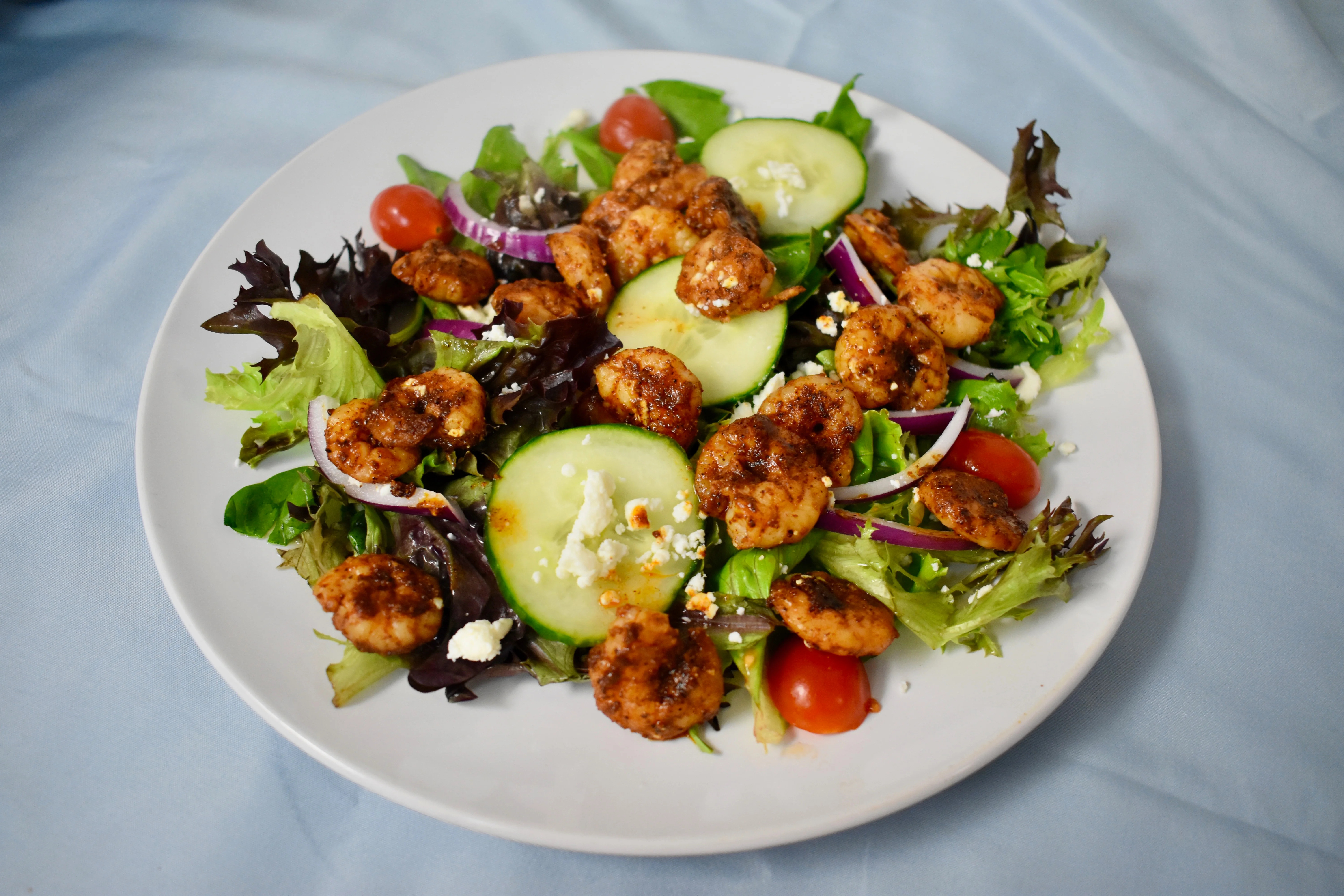 Grilled shrimp salad with mixed greens and feta cheese
