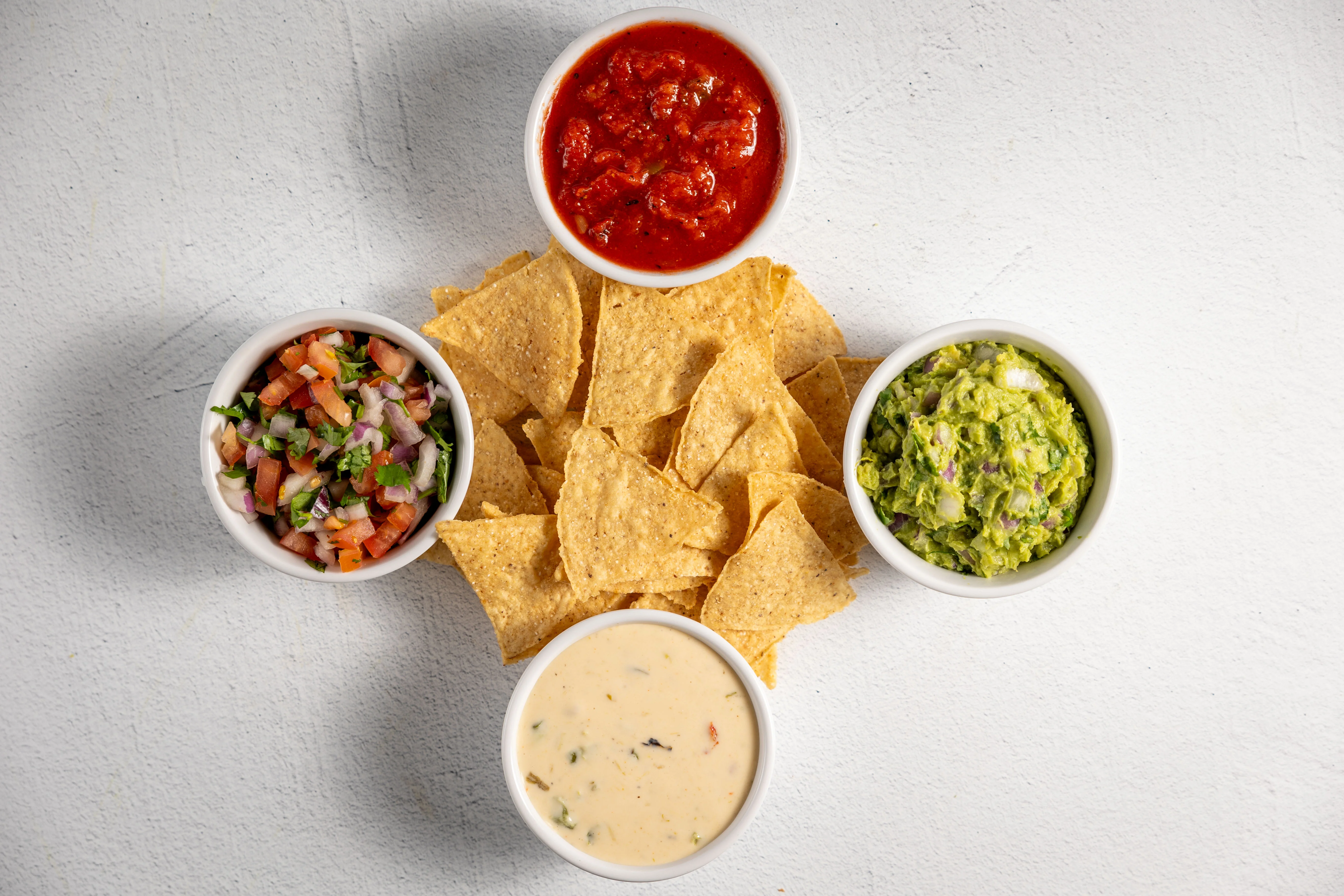 Mexican nachos with salsa, guacamole, and cheese dip