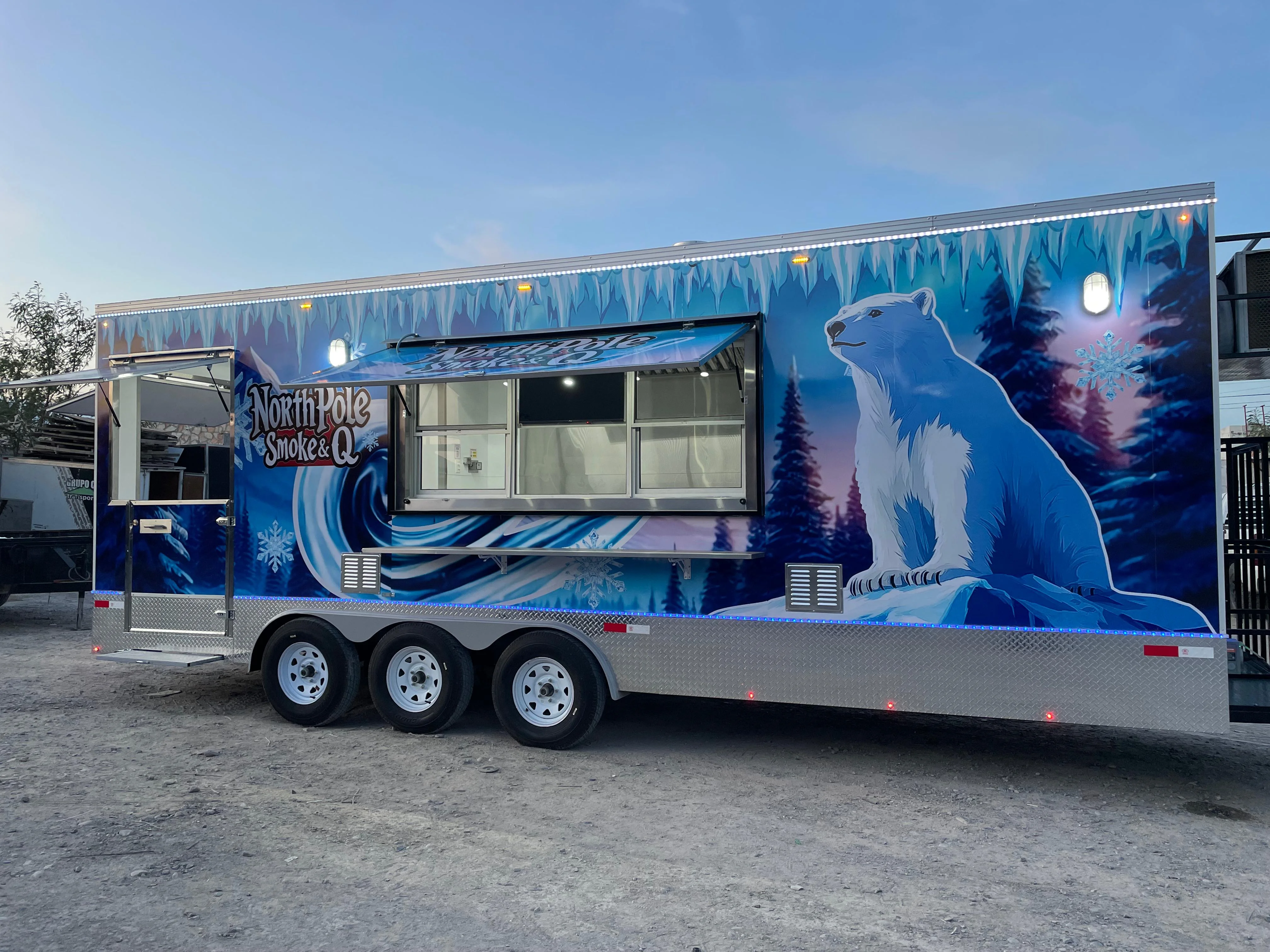 Colorful food truck named North Pole Smoke & Q