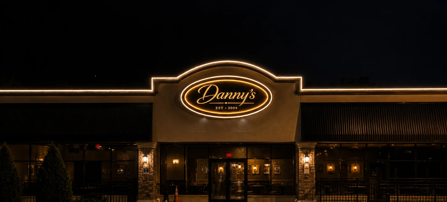 Exterior view of Danny's restaurant at night with illuminated signage