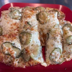 Freshly baked Margherita pizza served on a wooden peel