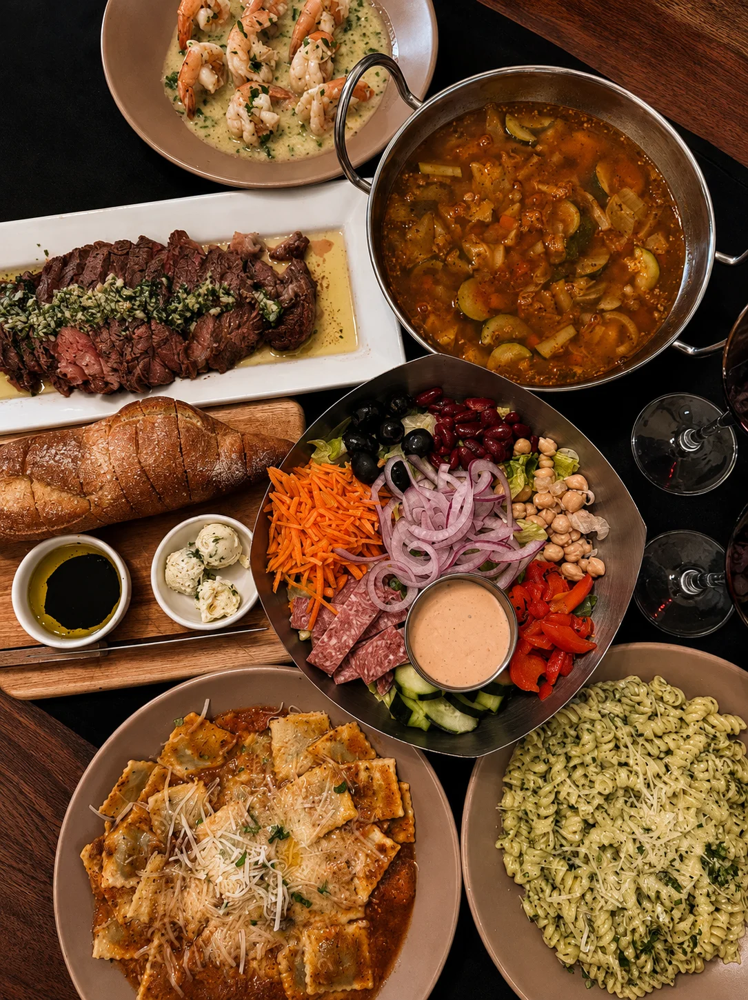 Gathering around a rustic table with diverse dishes and wine
