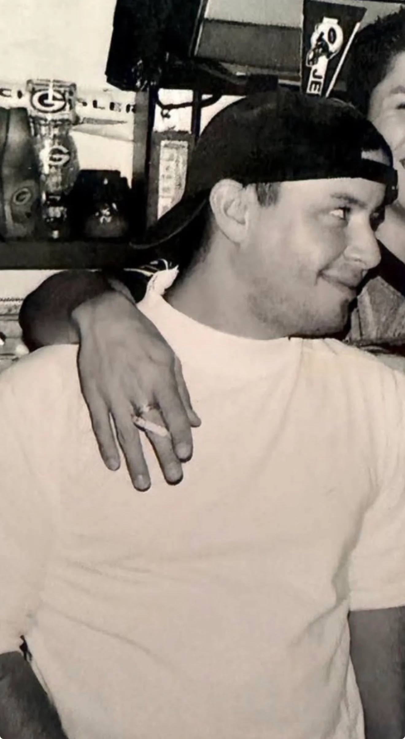 Black-and-white portrait of a restaurant kitchen worker wearing a cap and apron