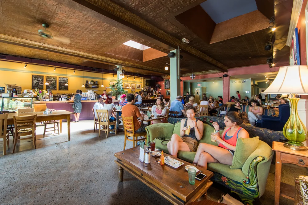 Cozy café interior with patrons enjoying drinks and conversation
