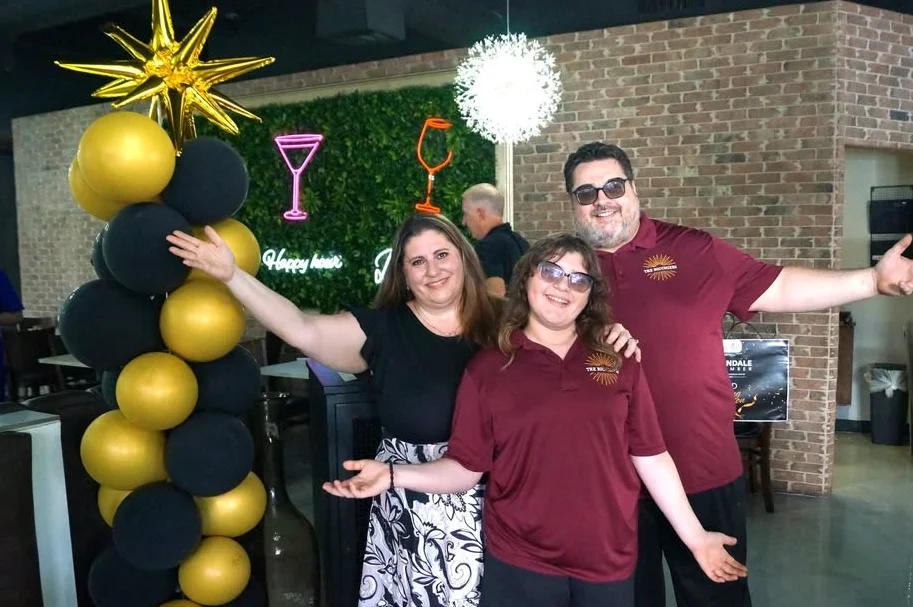 Cheerful restaurant staff celebrating in a vibrant dining space
