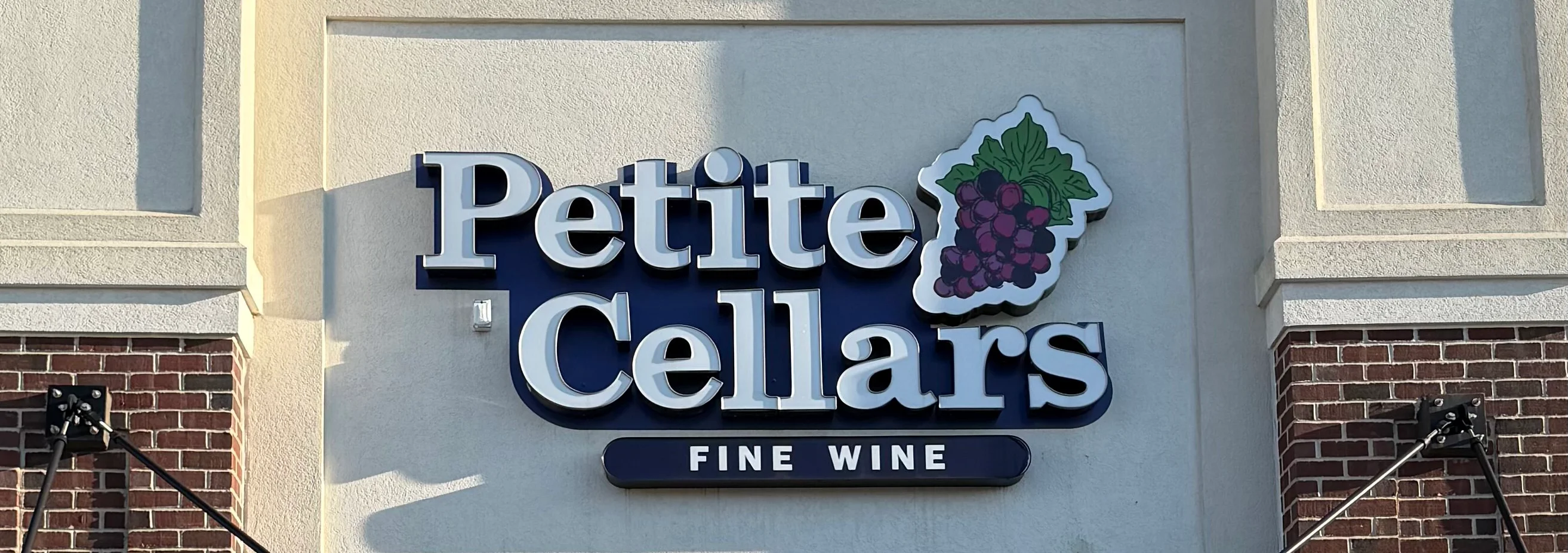 Entrance of Petite Cellars Fine Wine store with open sign