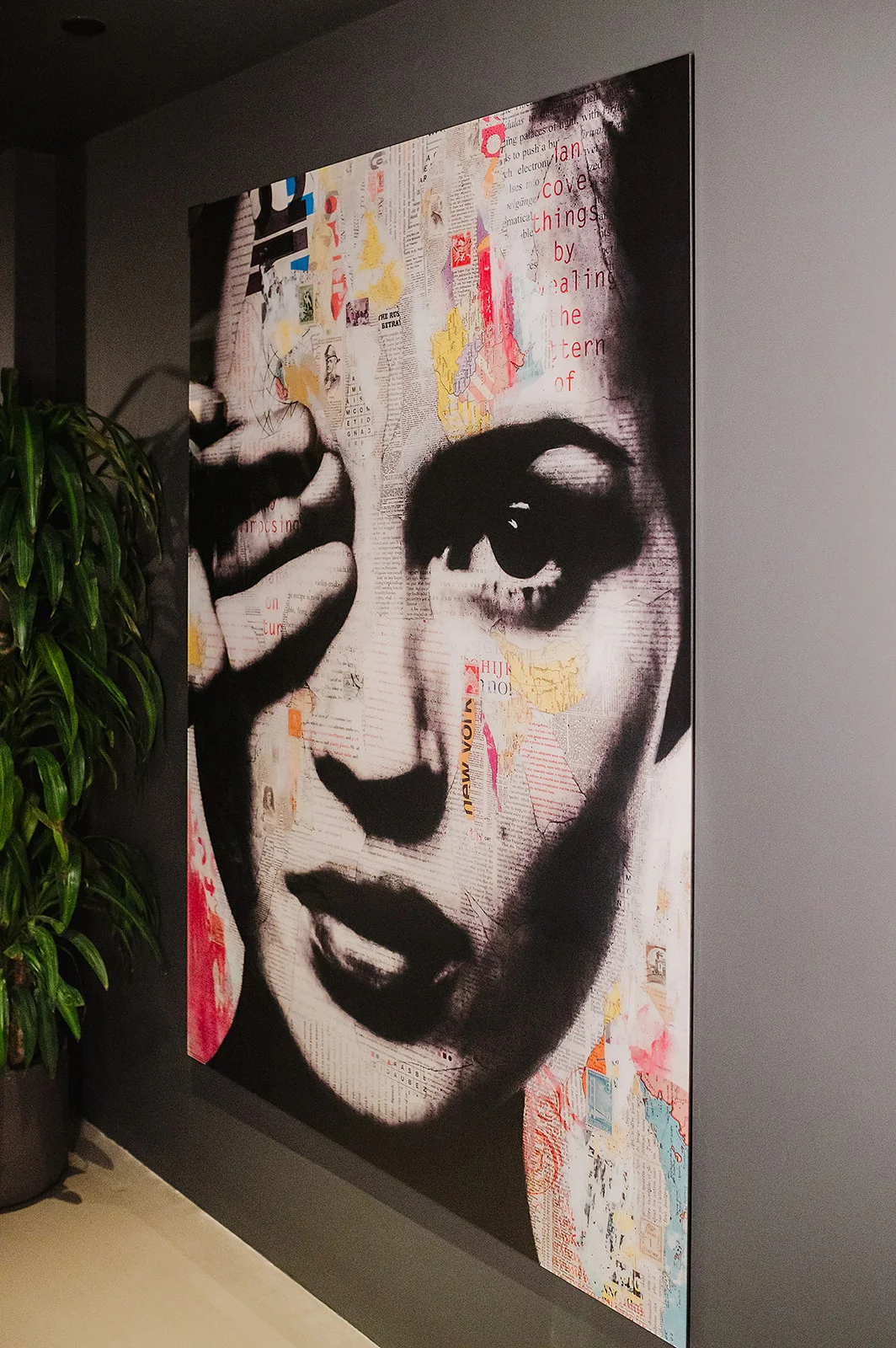 Artistic mural featuring a woman's face with mixed media elements