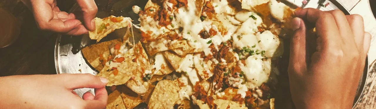 Loaded nachos topped with cheese and toppings