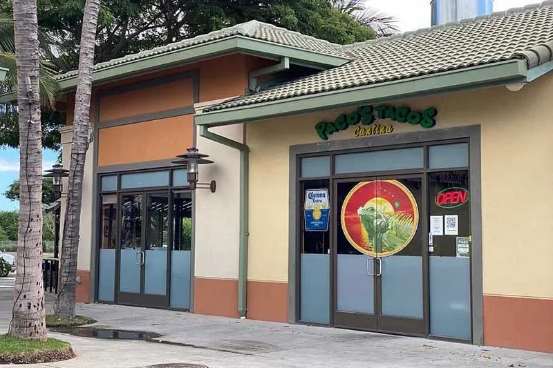 Exterior view of a vibrant Mexican cantina with open sign