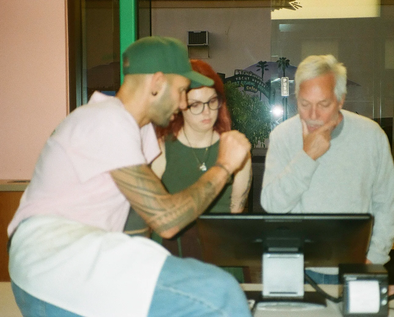 Staff collaborating at a restaurant computer station