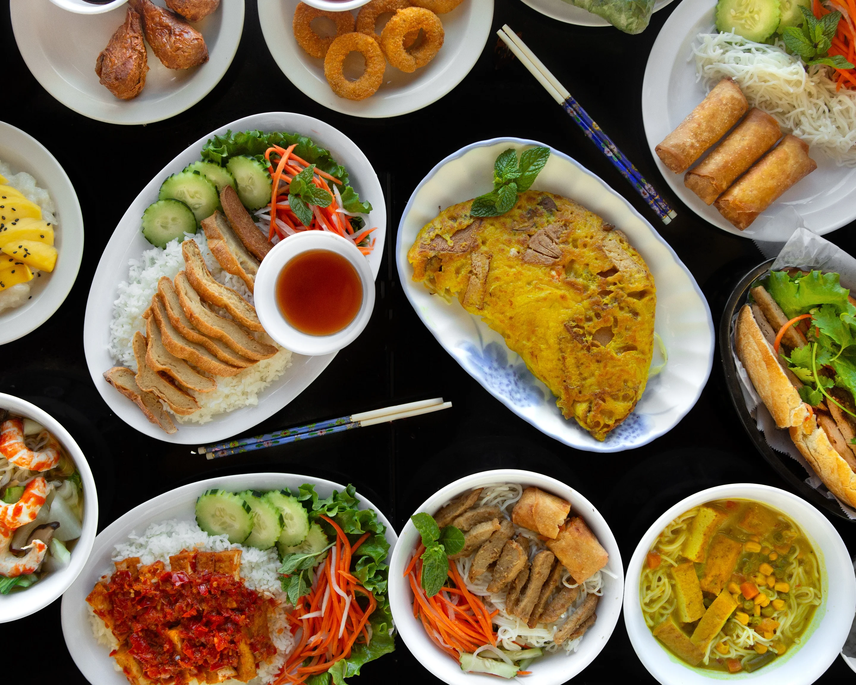 Assorted Vietnamese dishes including banh xeo and pho