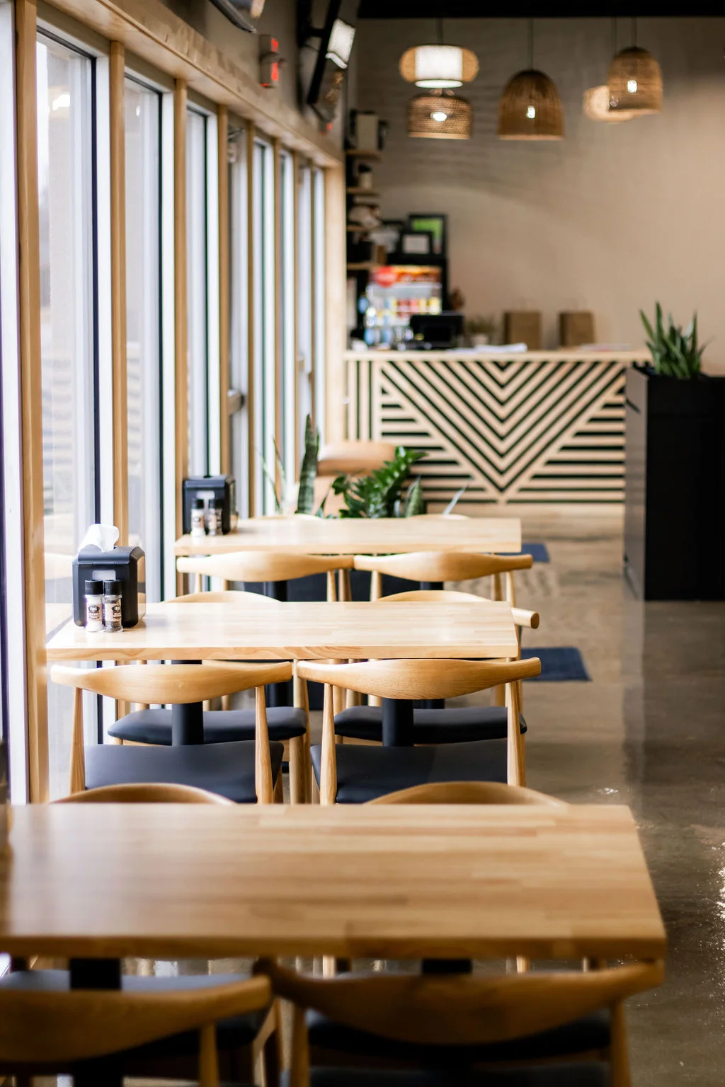 Modern restaurant interior with wooden tables and natural light