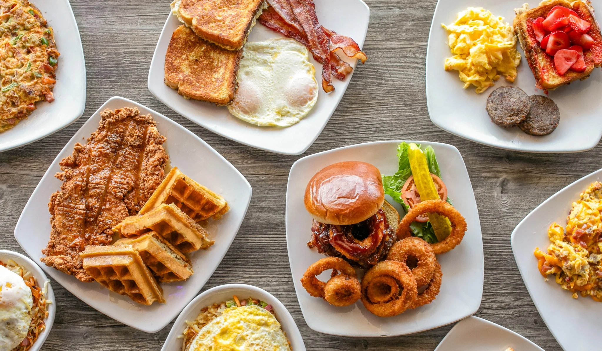 Hearty American breakfast platter with eggs, bacon, and waffles
