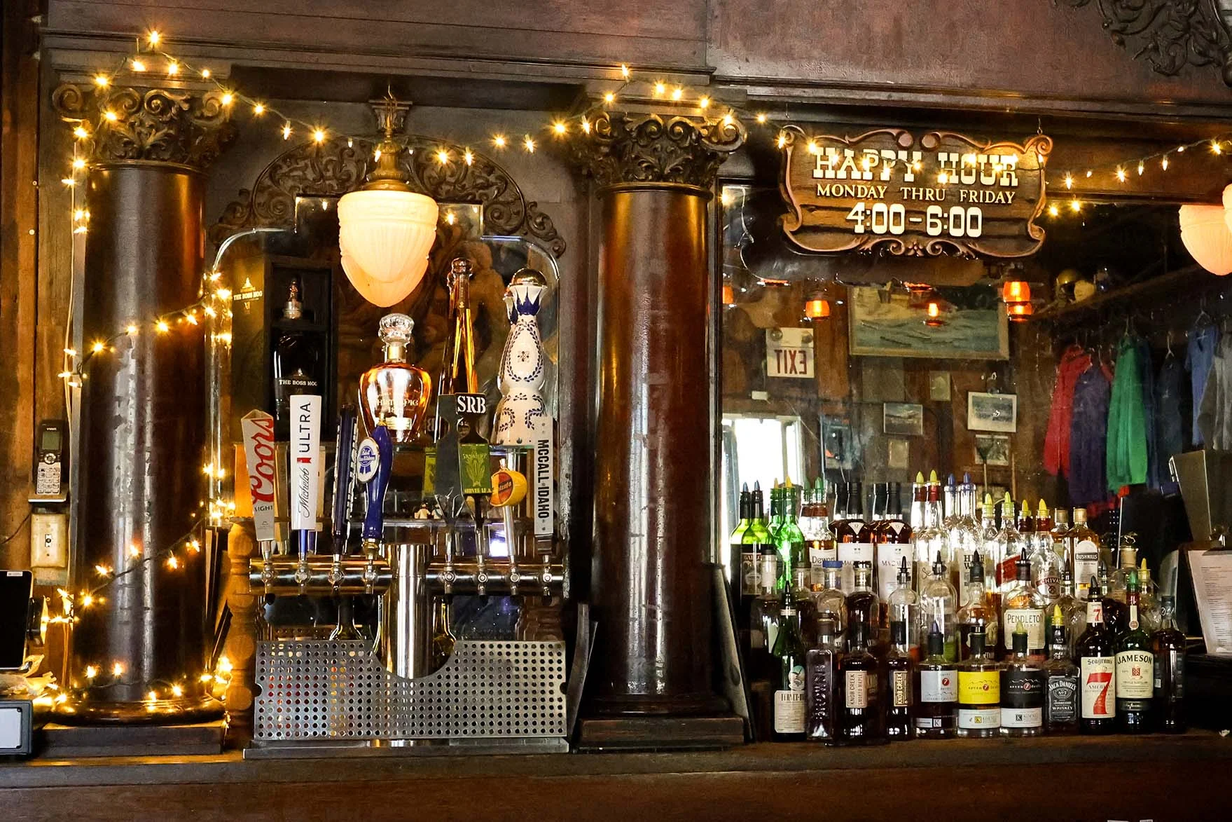 Cozy bar interior with vintage decor and happy hour sign