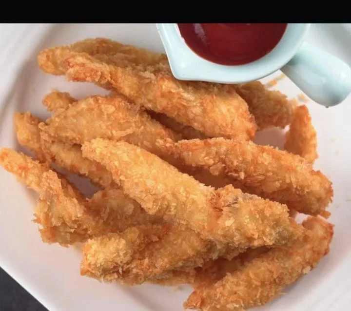 Crispy fried fish fillets with ketchup