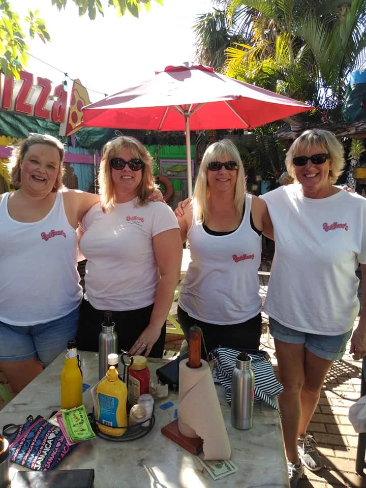 Group of friends enjoying a sunny day at a vibrant outdoor restaurant