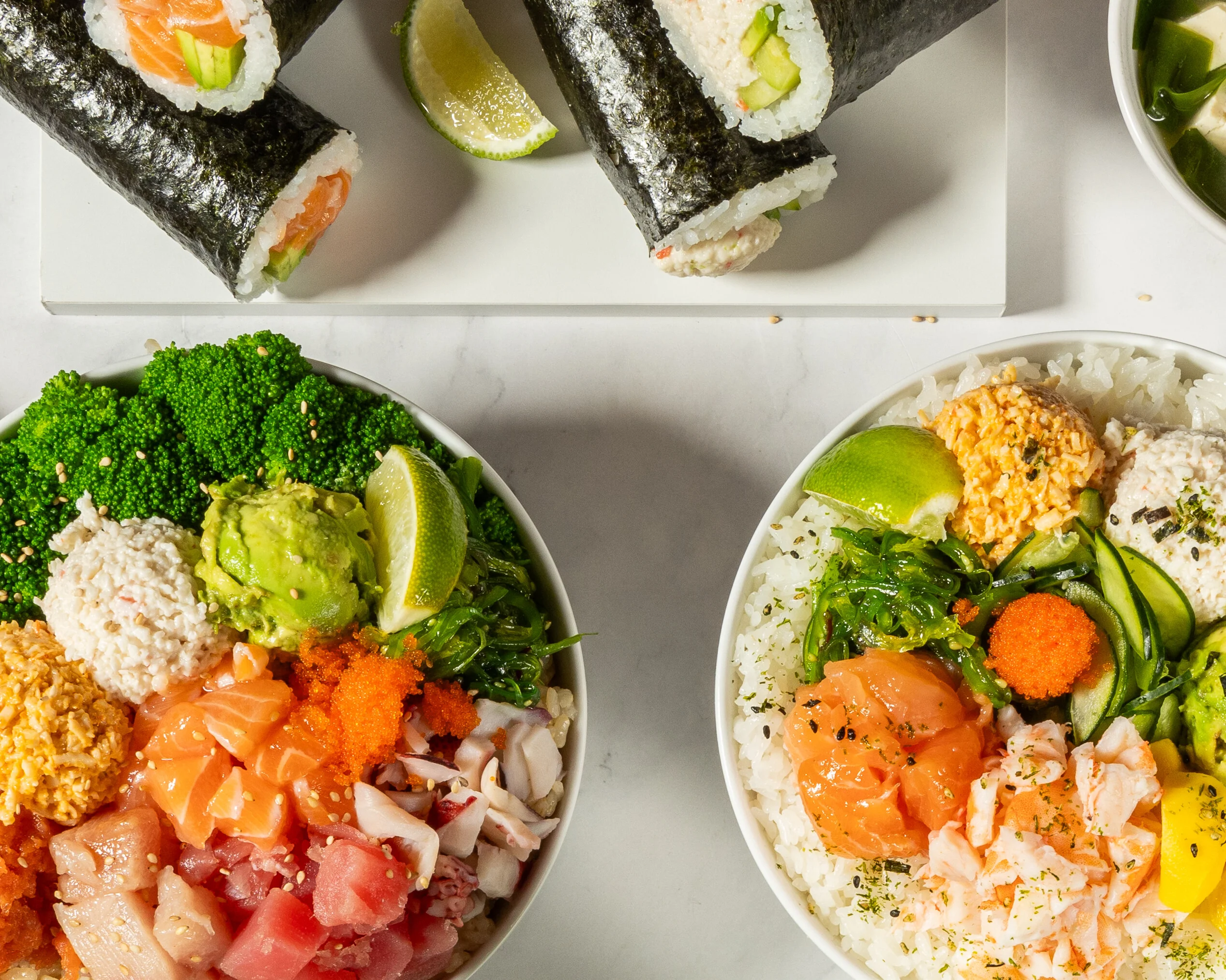 Japanese sushi and sashimi platter with colorful rice bowls