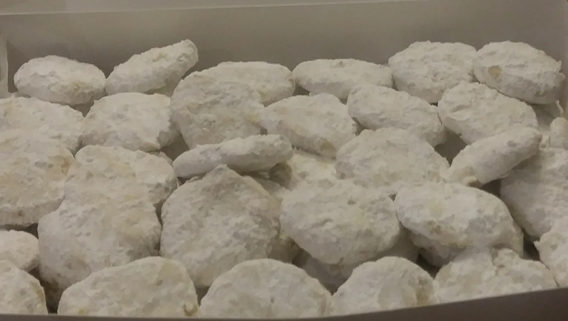 Traditional Greek kourabiedes cookies dusted with powdered sugar