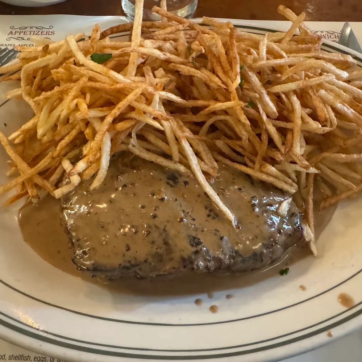 Classic French steak frites with creamy sauce and crispy fries