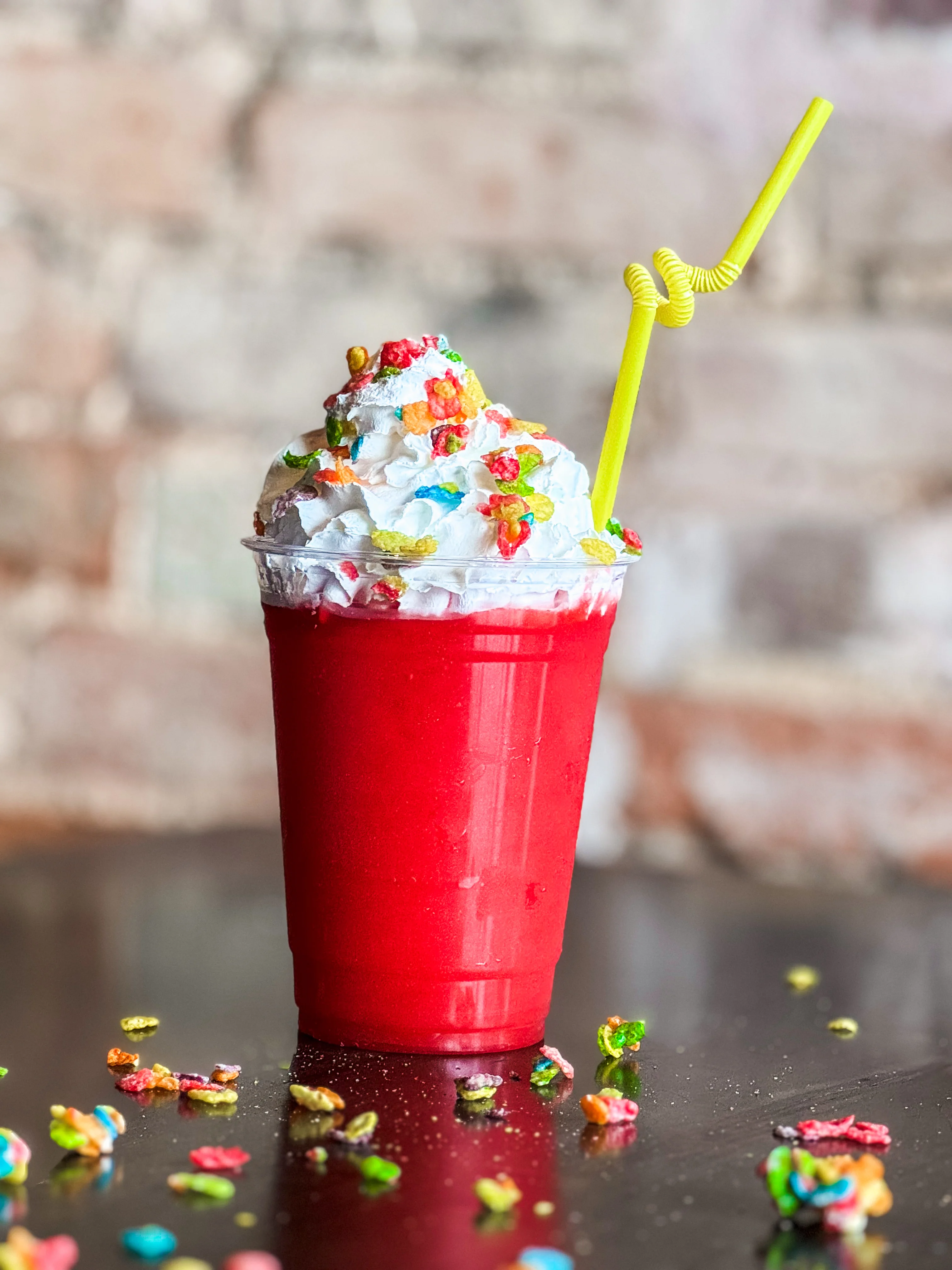 Colorful milkshake topped with whipped cream and cereal