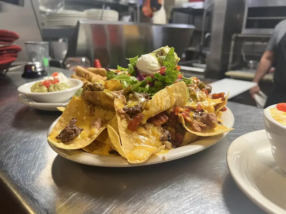 Loaded nachos topped with cheese and fresh toppings
