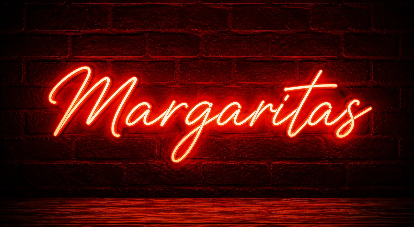 Neon sign displaying 'Margaritas' in a vibrant bar setting