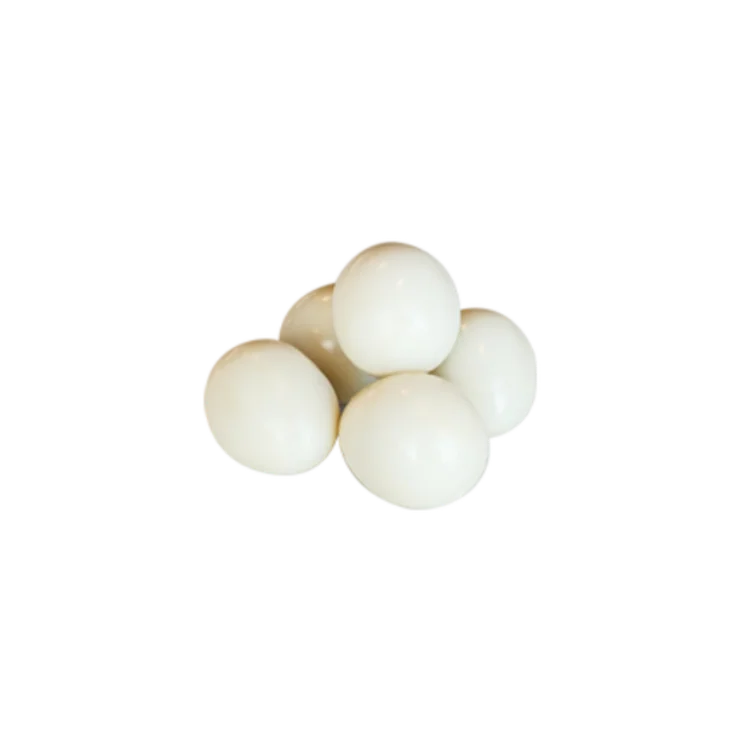 Fresh white eggs stacked in a pile