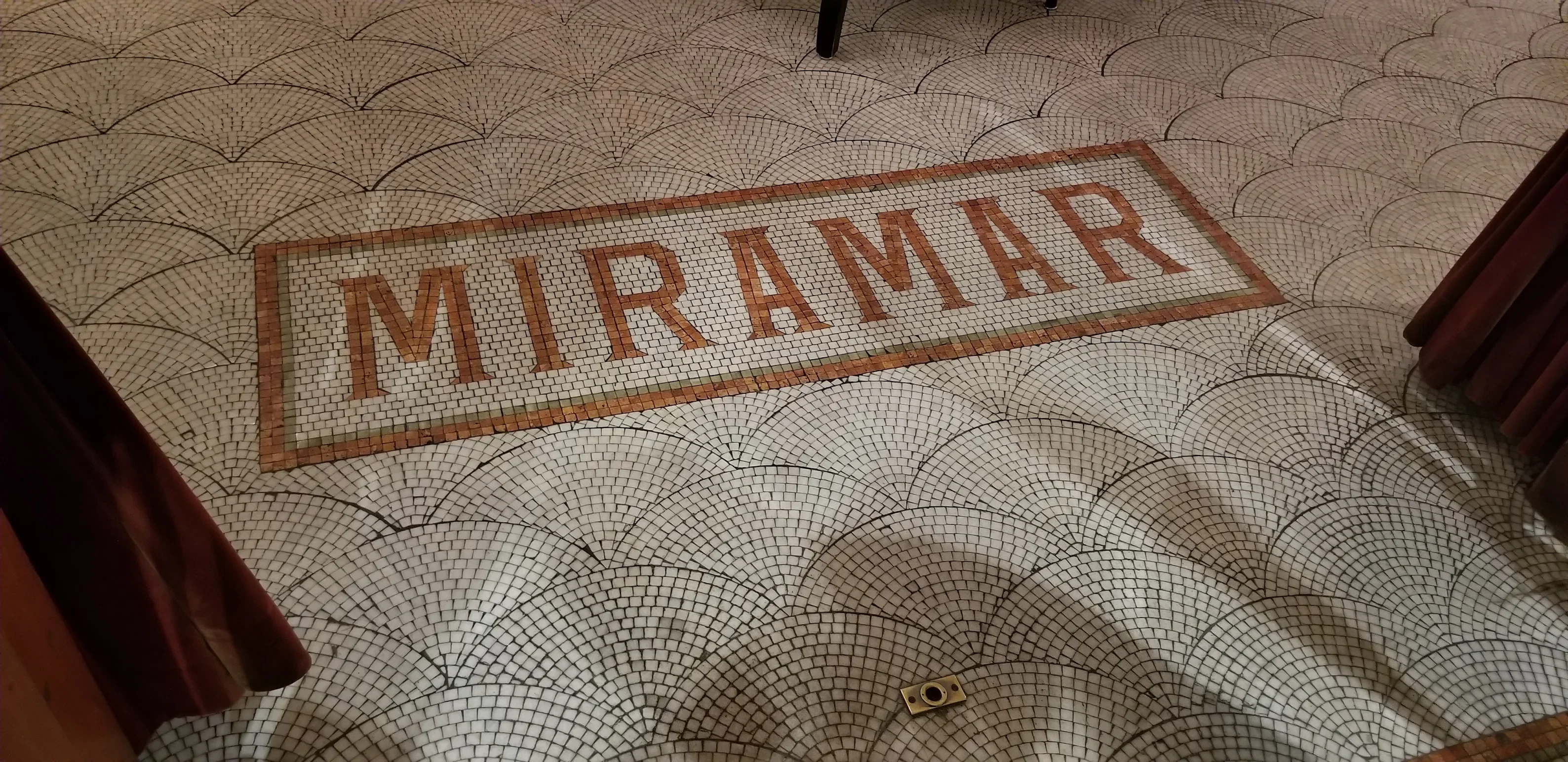 Elegant mosaic floor with the name 'MIRAMAR' in a restaurant setting