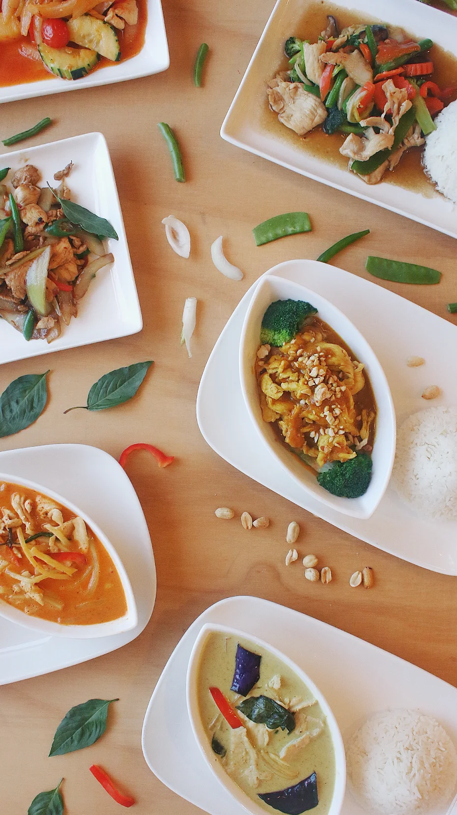 Assorted Thai curries with rice and fresh vegetables