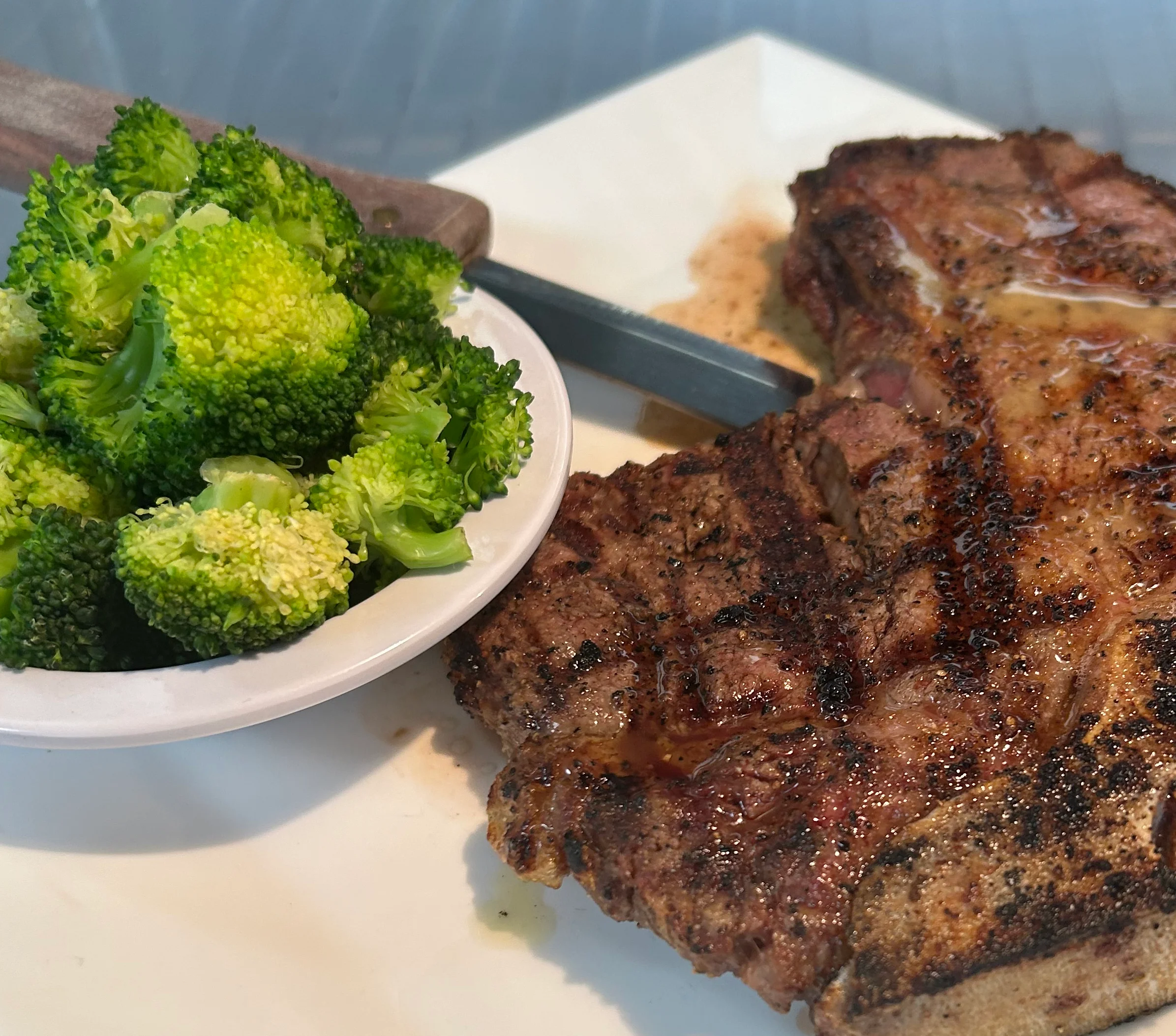 Grilled ribeye steak with steamed broccoli