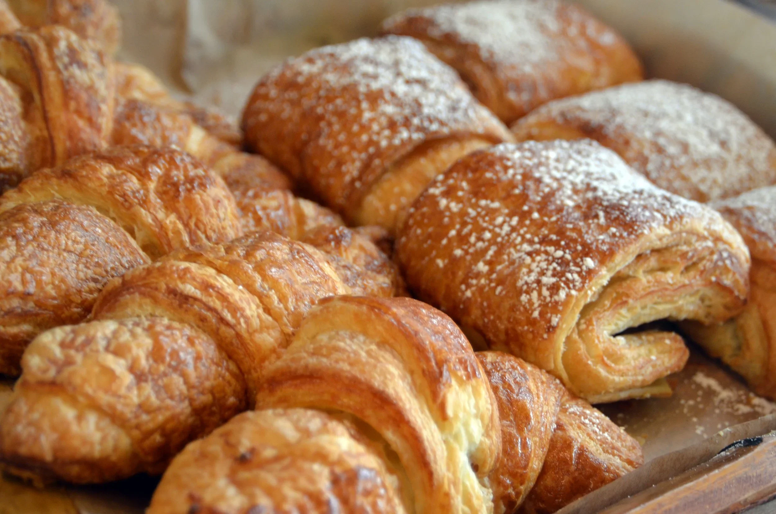 A variety of freshly baked goods displayed in a bakery.