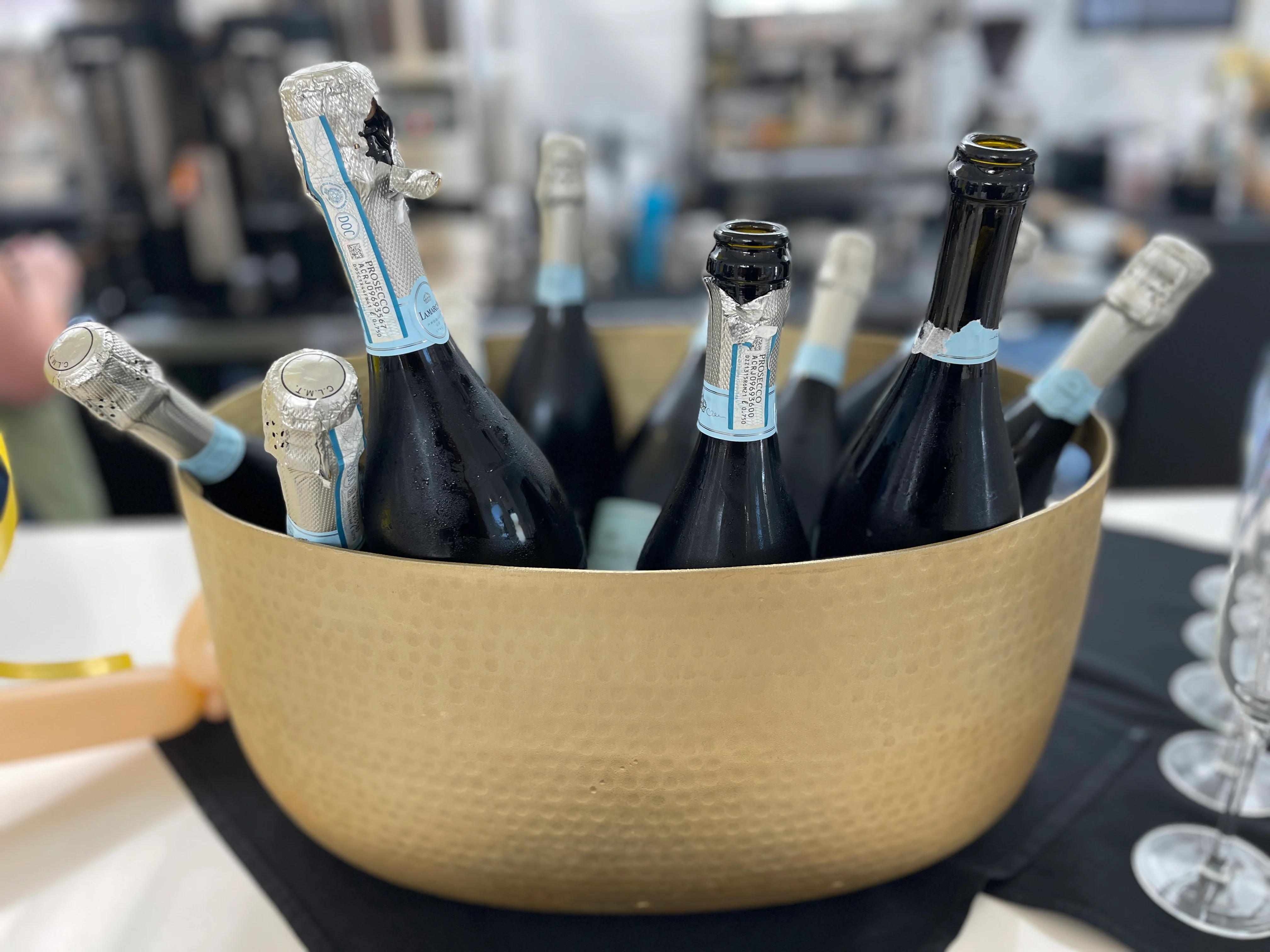 Chilled sparkling wine bottles in a gold ice bucket
