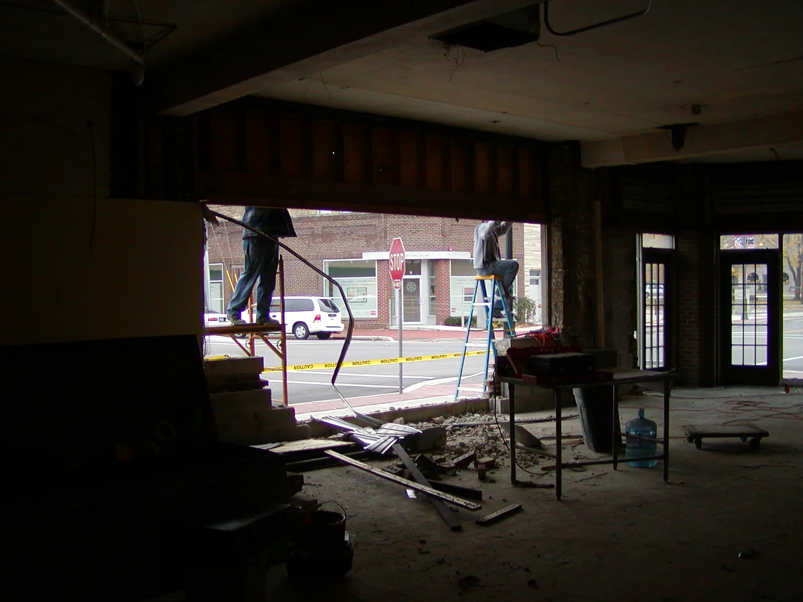 Building renovation in progress with a worker on a ladder