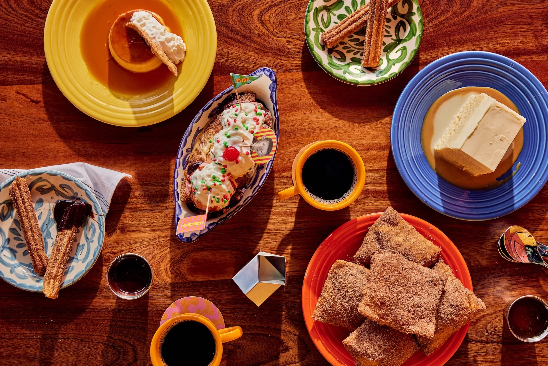 Colorful Mexican desserts including flan and churros