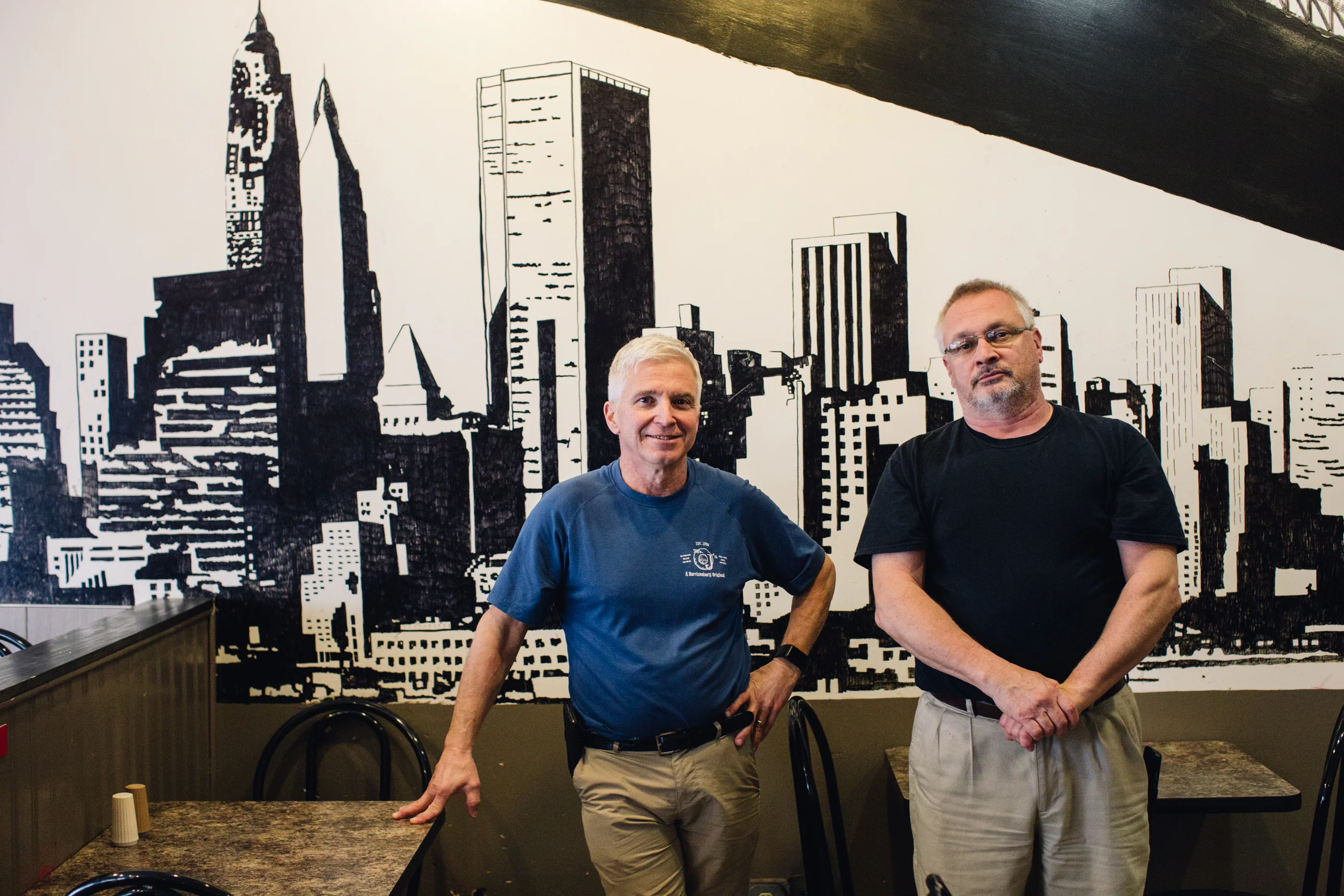 Cozy restaurant interior with a city skyline mural