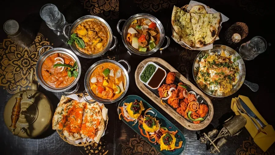 Assorted Indian curries and naan served on a decorative table