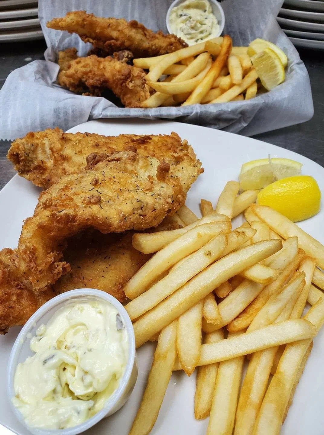 Crispy fried fish and chips served with tartar sauce