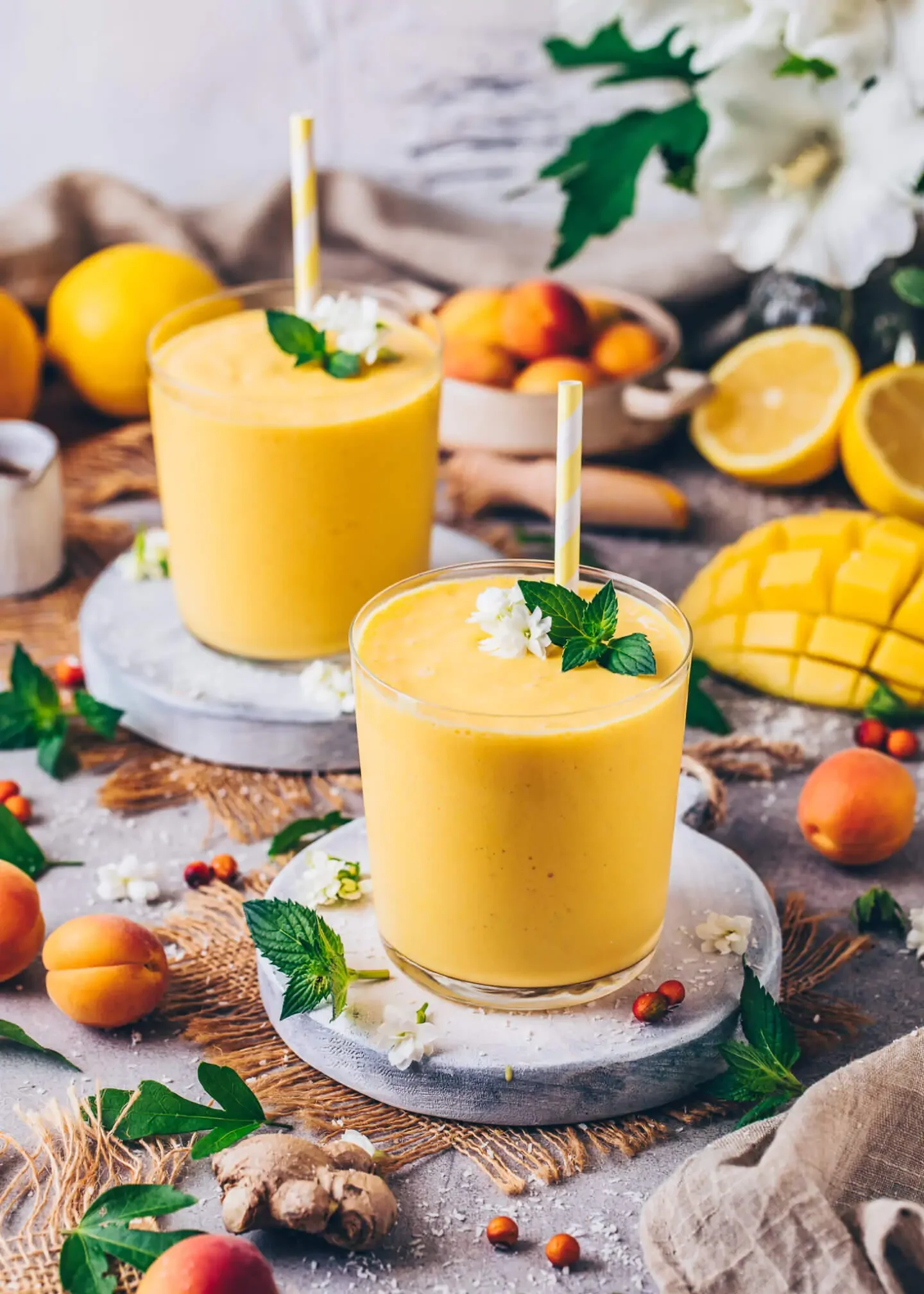 Tropical mango smoothie in a glass with mint garnish