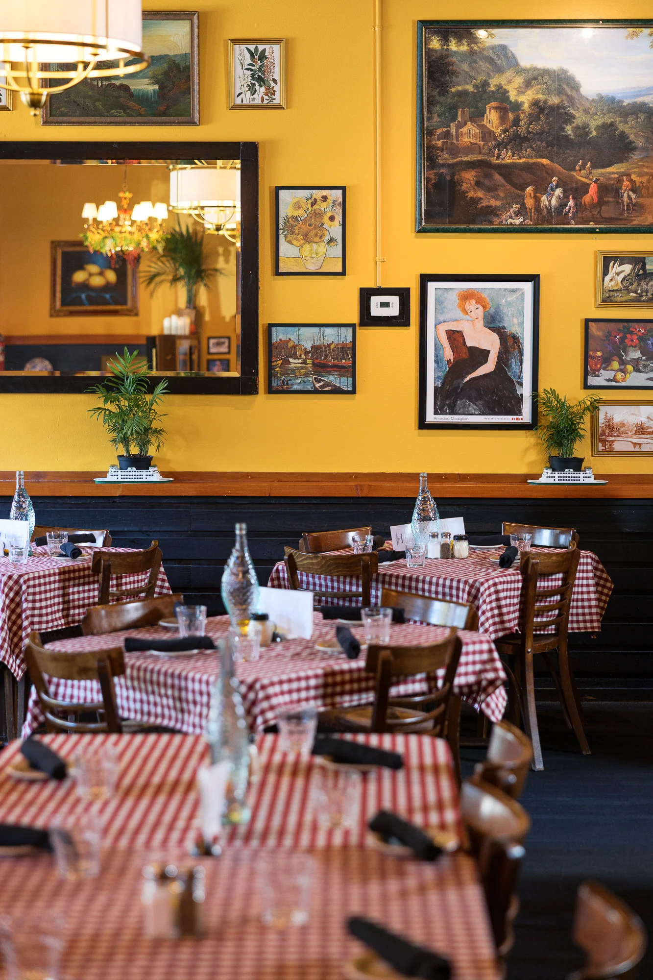 Charming restaurant interior with vibrant yellow walls and checkered tablecloths